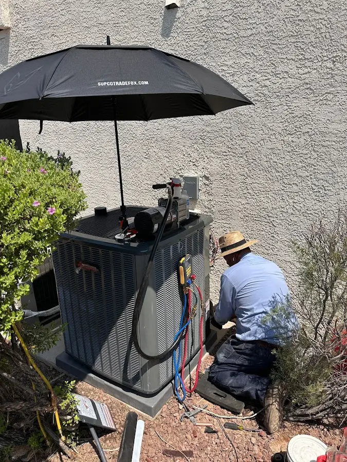 HVAC technician performing outdoor AC maintenance in Salem
